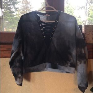 A cropped tie die sweater with crossed v neck